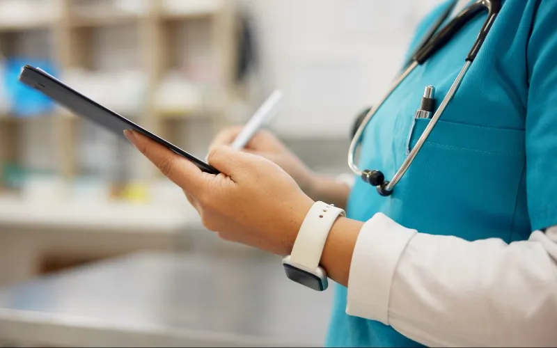 vet and hands writing with tablet for research on animal
